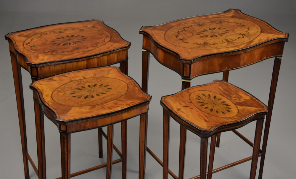 A set of four Edwardian Sheraton style nested tables crafted from inlaid wood with serpentine tops and tapered legs. View V