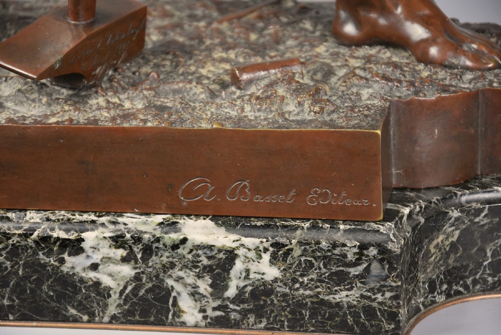 A dark brown patinated bronze sculpture of a standing male figure resting on a rectangular marble base with an etched metal title plaque. View XV
