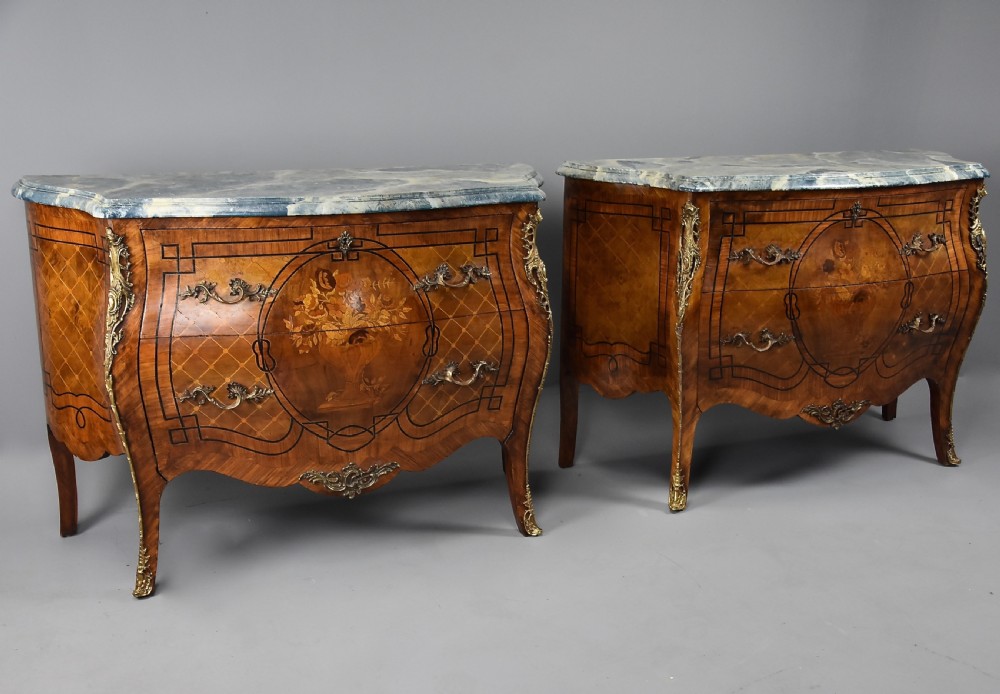 A pair of early 20th century French kingwood bombe commodes with floral marquetry inlay, gilt-bronze mounts, and marble tops. View II