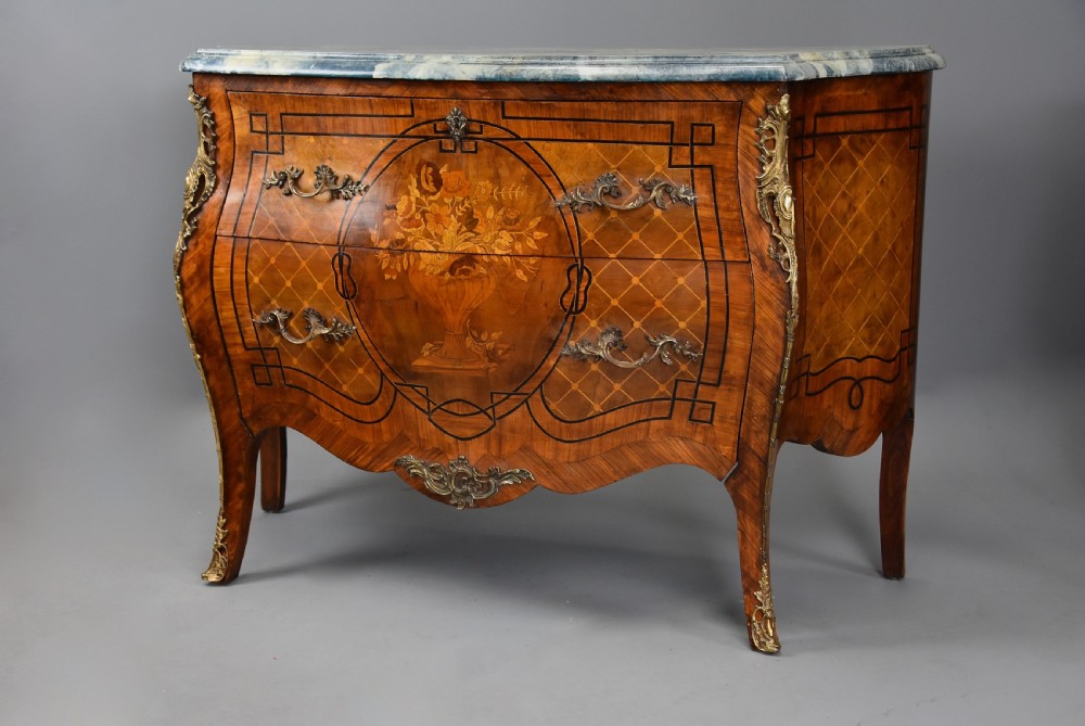 A pair of early 20th century French kingwood bombe commodes with floral marquetry inlay, gilt-bronze mounts, and marble tops. View VI