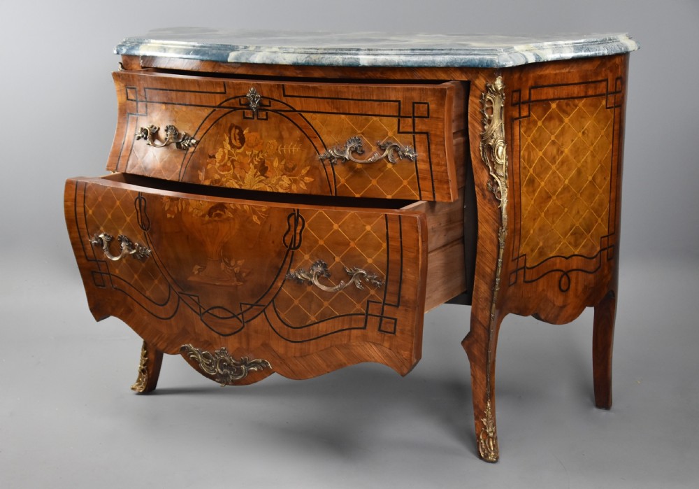 A pair of early 20th century French kingwood bombe commodes with floral marquetry inlay, gilt-bronze mounts, and marble tops. View IX