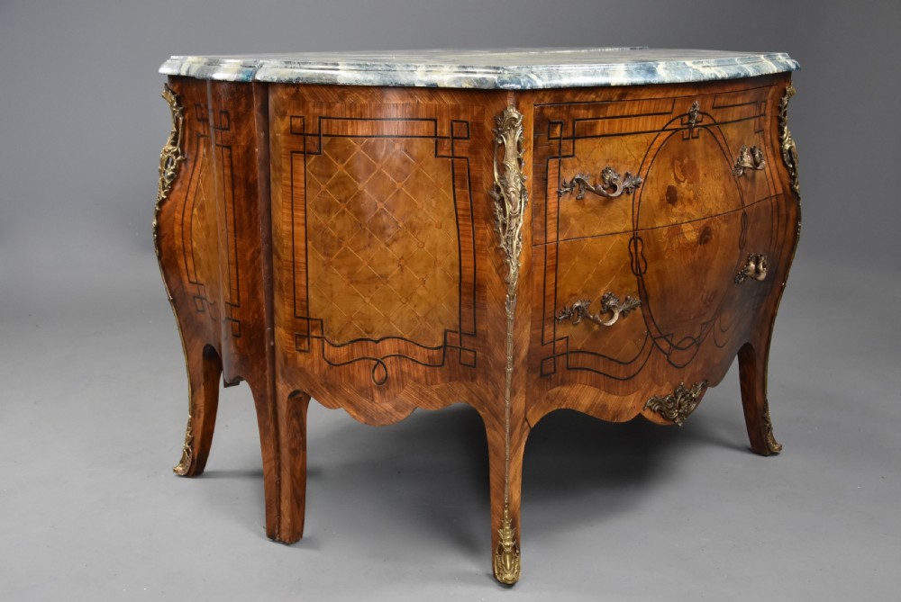 A pair of early 20th century French kingwood bombe commodes with floral marquetry inlay, gilt-bronze mounts, and marble tops. View XII