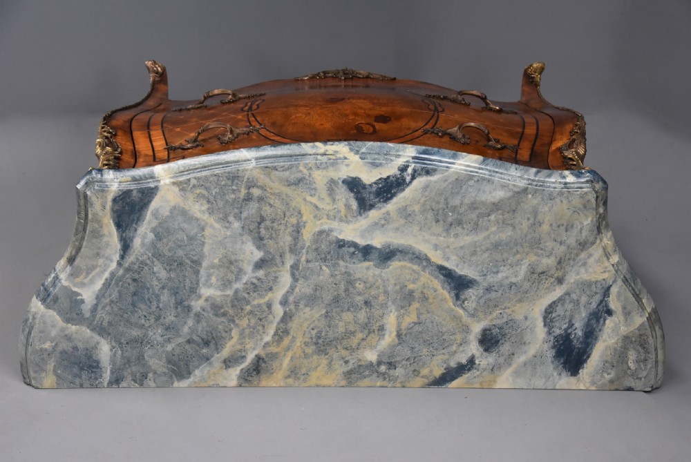 A pair of early 20th century French kingwood bombe commodes with floral marquetry inlay, gilt-bronze mounts, and marble tops. View XV