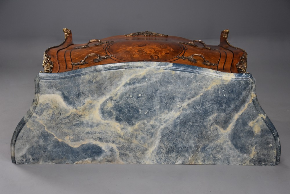 A pair of early 20th century French kingwood bombe commodes with floral marquetry inlay, gilt-bronze mounts, and marble tops. View XVI