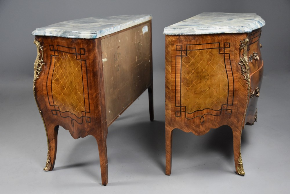 A pair of early 20th century French kingwood bombe commodes with floral marquetry inlay, gilt-bronze mounts, and marble tops. View XVII