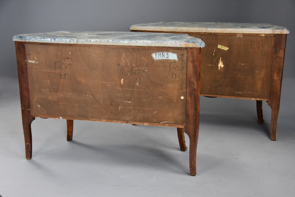 A pair of early 20th century French kingwood bombe commodes with floral marquetry inlay, gilt-bronze mounts, and marble tops. View XVIII