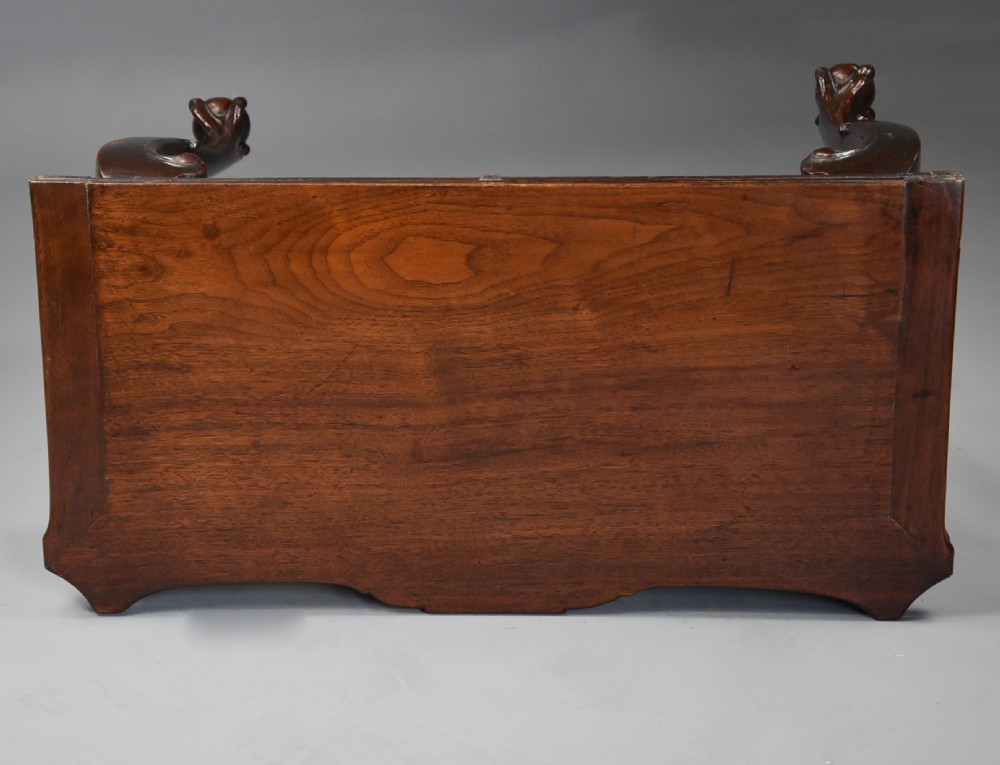 A dark walnut fold-over tea table featuring cabriole legs with carved knees ending in ball-and-claw feet and a decorative carved apron. View X