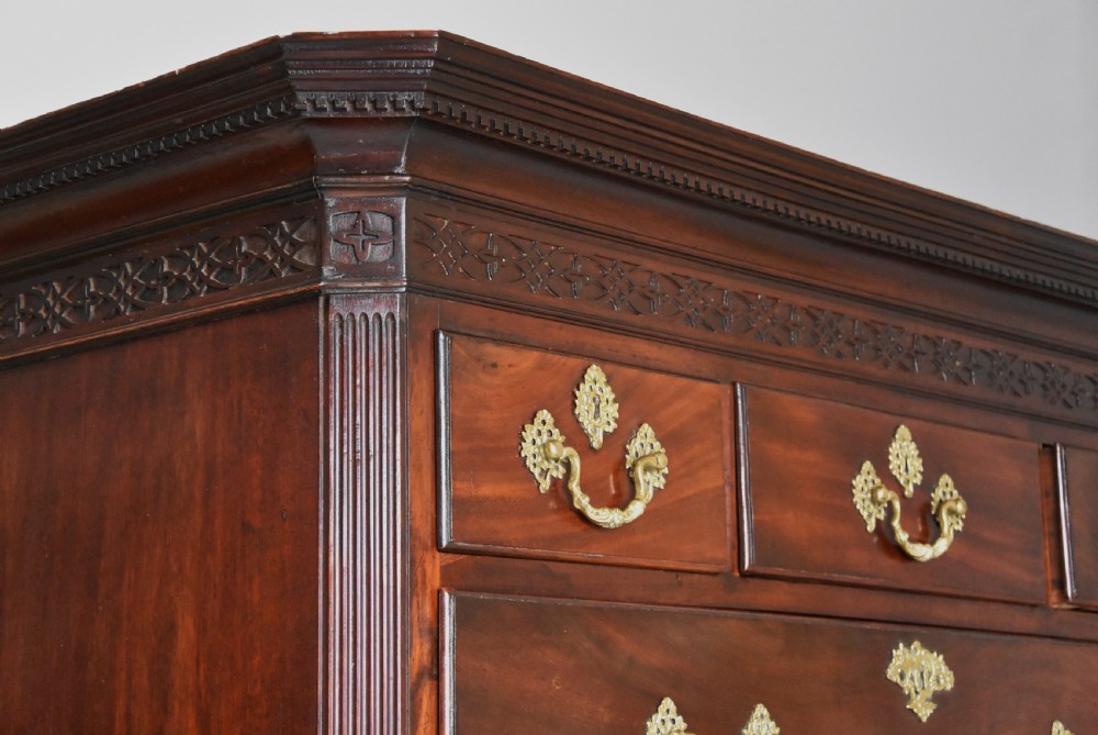 A mid-18th-century Georgian mahogany chest on chest featuring brass swan-neck handles, fluted chamfered corners, and ogee bracket feet. View V