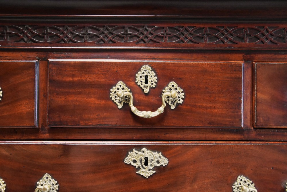 A mid-18th-century Georgian mahogany chest on chest featuring brass swan-neck handles, fluted chamfered corners, and ogee bracket feet. View VII