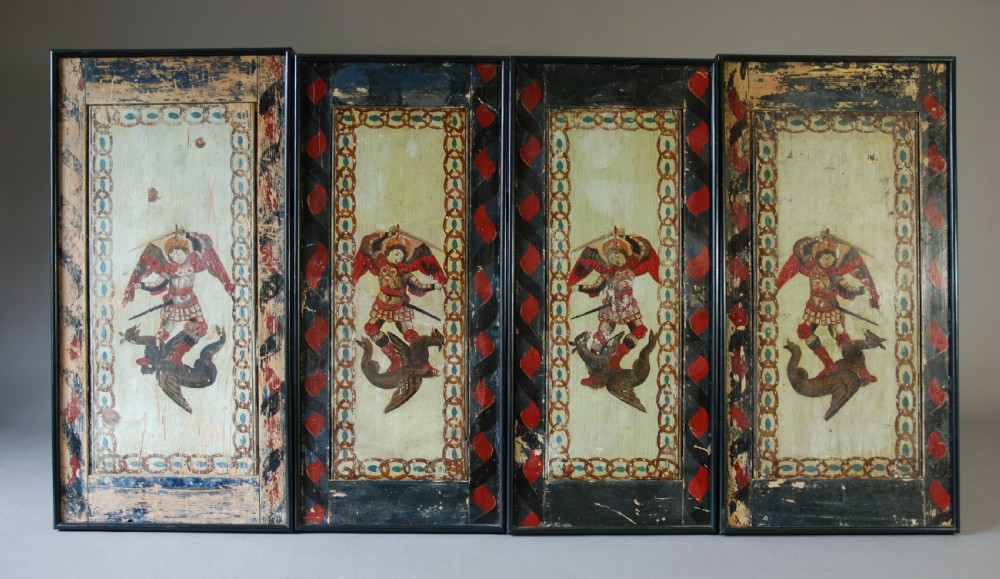 A set of four rectangular vertical pine panels decorated with naive paintings of Saint Michael slaying a winged dragon within chainlink borders. View IV