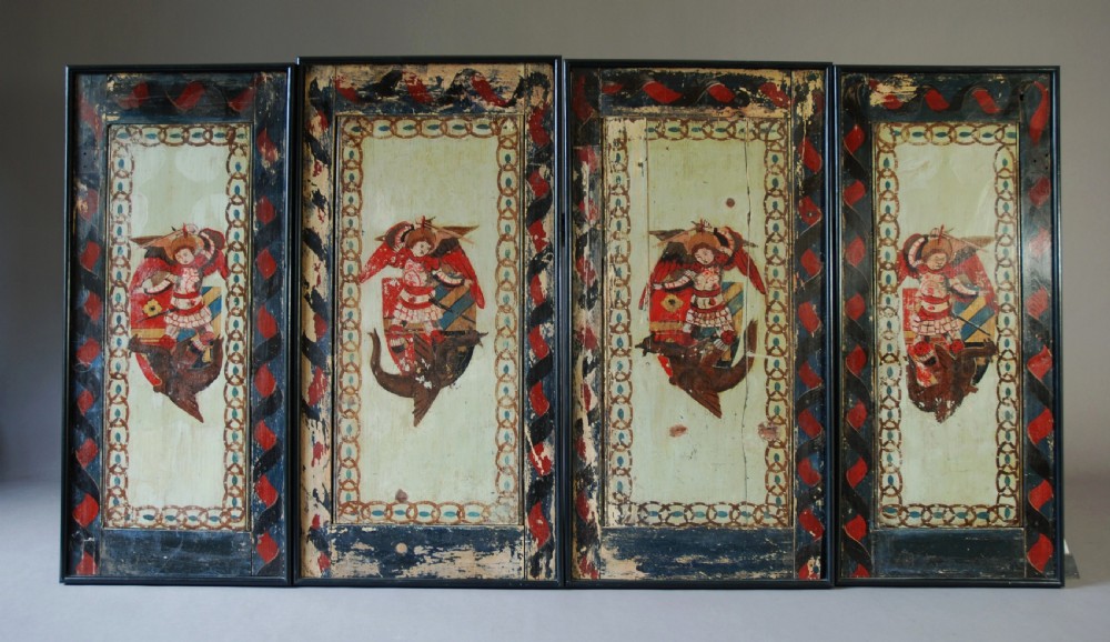 A set of four rectangular vertical pine panels decorated with naive paintings of Saint Michael slaying a winged dragon within chainlink borders. View X