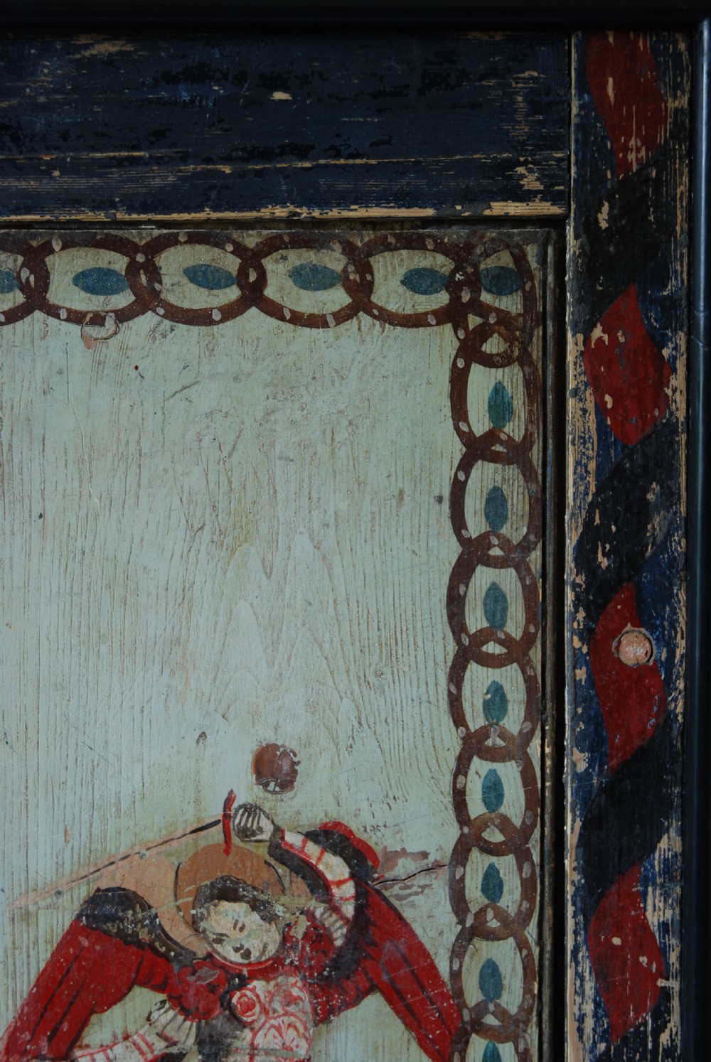 A set of four rectangular vertical pine panels decorated with naive paintings of Saint Michael slaying a winged dragon within chainlink borders. View XI