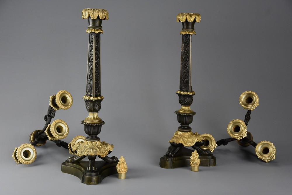 A pair of mid-19th century French Regence style candelabra crafted from patinated dark bronze with gilt bronze foliage mounts and three scrolled branches. View VII