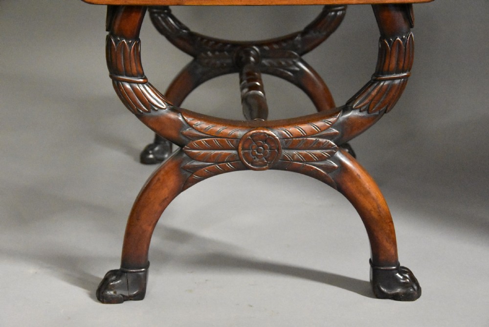 An early nineteenth-century French Empire mahogany sofa table featuring two drop leaves, a drawer with brass mounts, carved legs, and a turned central stretcher. View IX