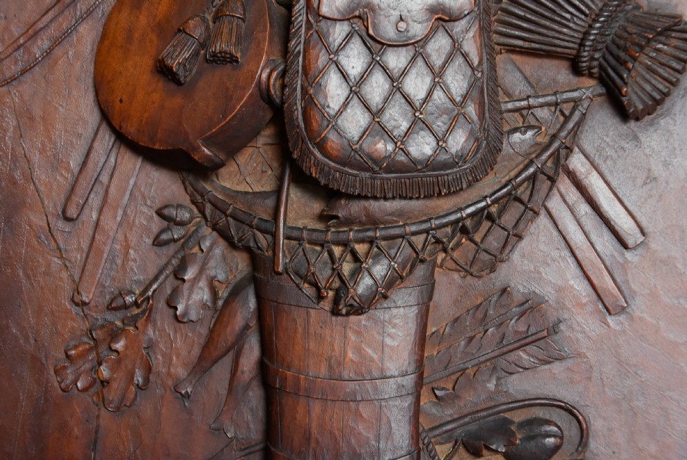 A framed mid-19th-century Continental fruitwood panel featuring a high-relief carved vertical trophy motif of hunting equipment, fruit, and foliage. View VIII