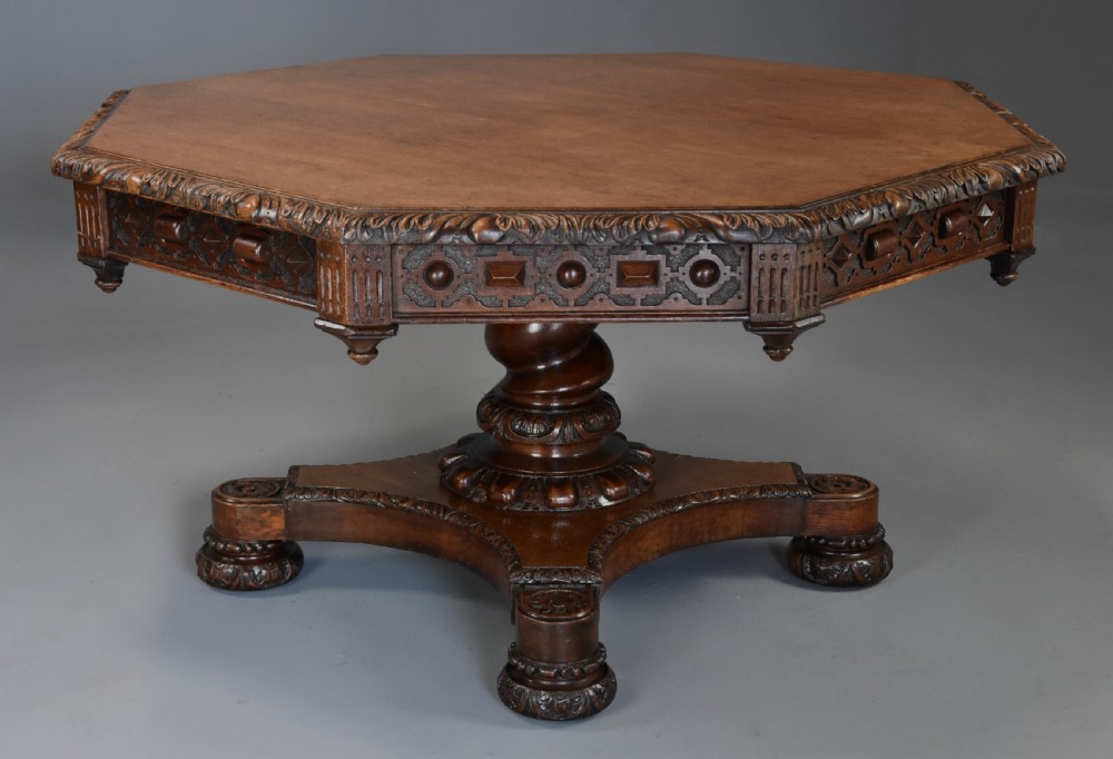 An early 19th-century octagonal carved oak library table with a central spiral pedestal and geometric strapwork frieze. View III