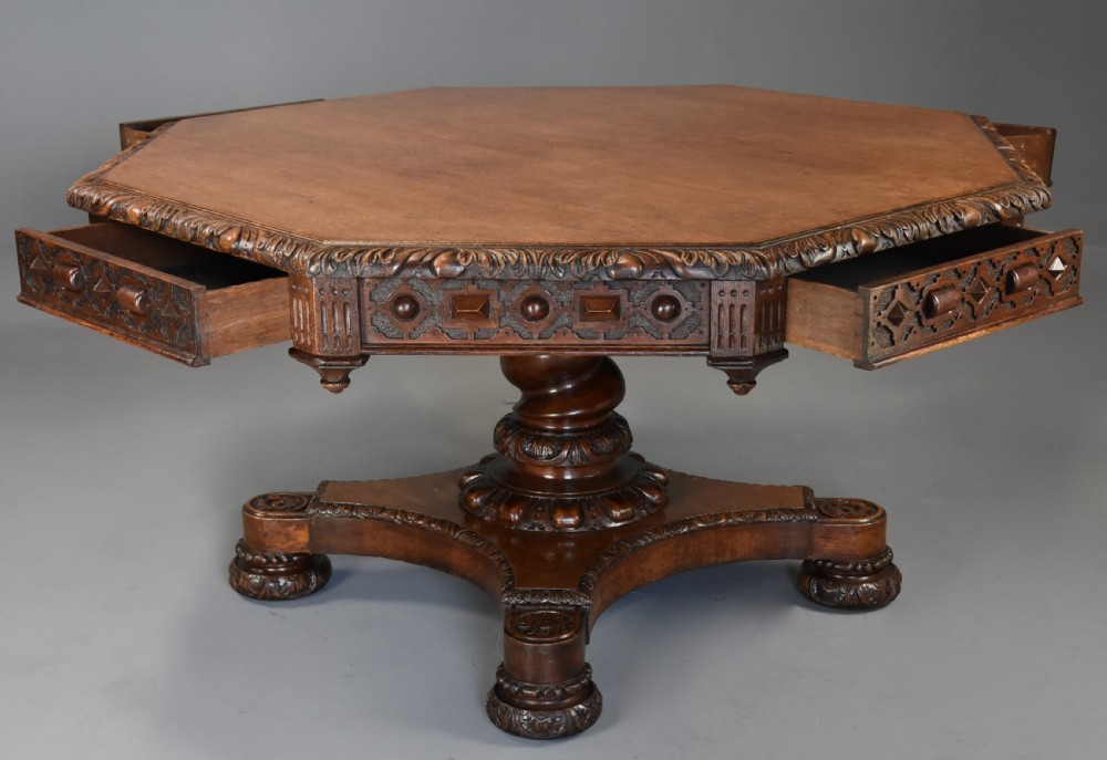 An early 19th-century octagonal carved oak library table with a central spiral pedestal and geometric strapwork frieze. View VI