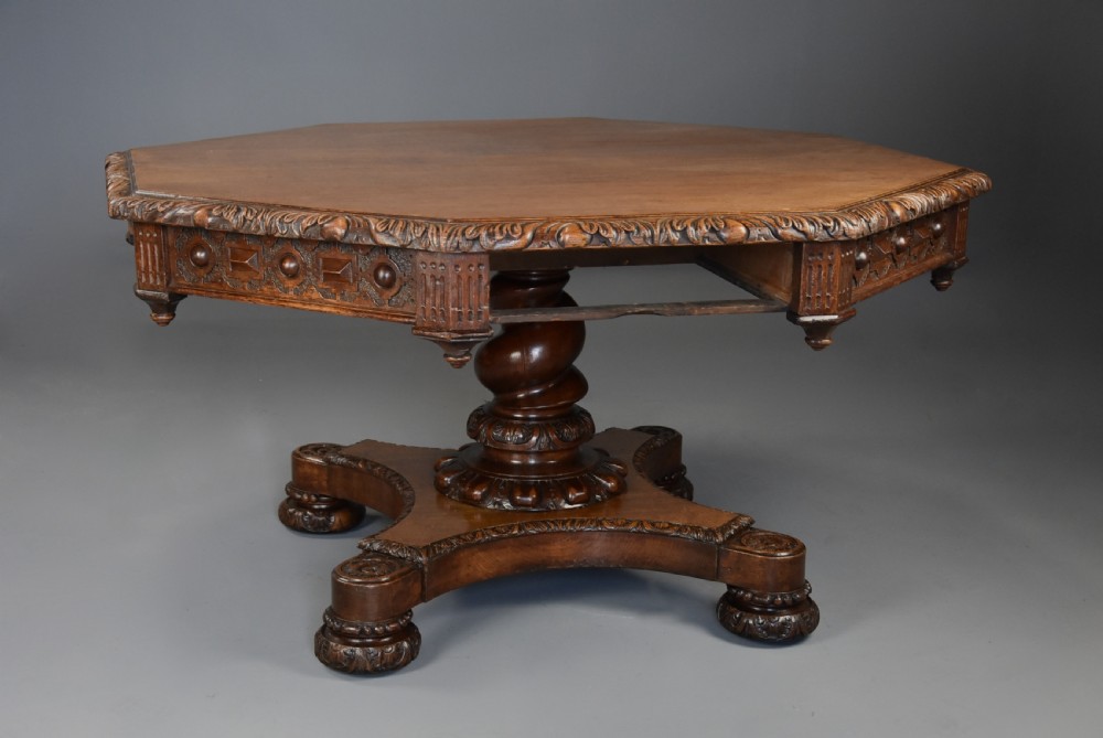 An early 19th-century octagonal carved oak library table with a central spiral pedestal and geometric strapwork frieze. View VII