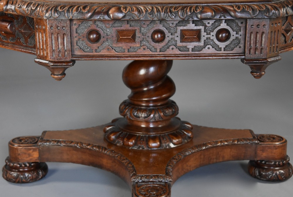 An early 19th-century octagonal carved oak library table with a central spiral pedestal and geometric strapwork frieze. View IX