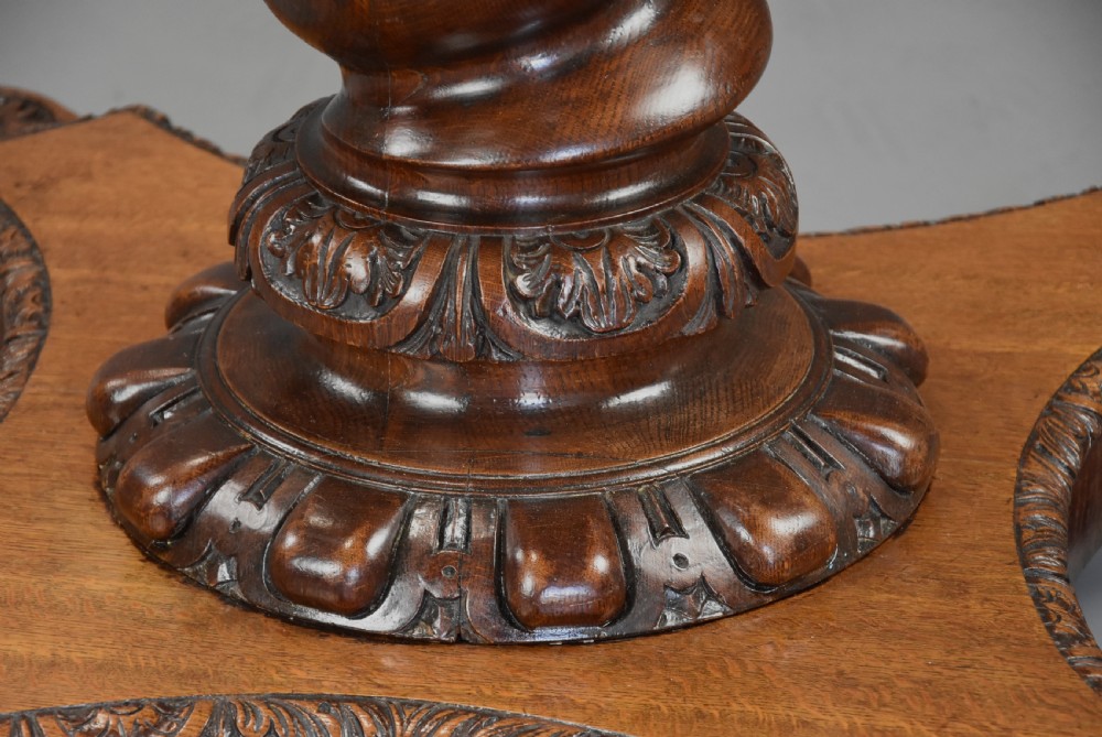 An early 19th-century octagonal carved oak library table with a central spiral pedestal and geometric strapwork frieze. View XIV