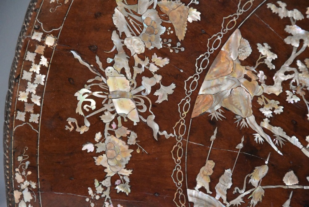A late 19th century circular dark hardwood centre table featuring mother of pearl floral inlay, a carved openwork apron, and a tripod pedestal base. View VII