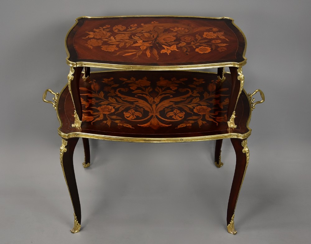 A two-tiered French style dark wood etagere featuring elaborate floral marquetry inlays, curved cabriole legs, and ornate gilt-bronze mounts along the rims and feet. View IV