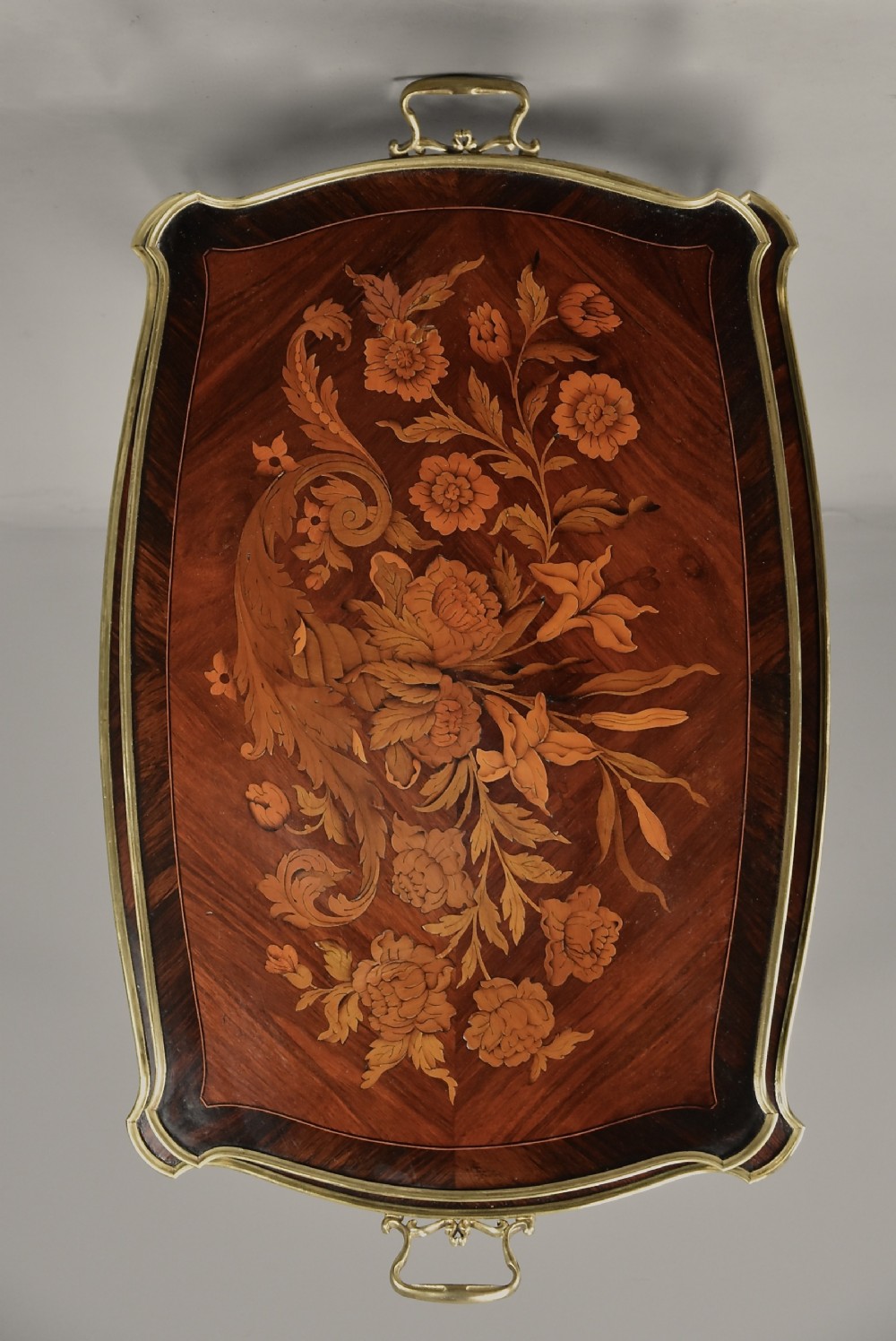 A two-tiered French style dark wood etagere featuring elaborate floral marquetry inlays, curved cabriole legs, and ornate gilt-bronze mounts along the rims and feet. View IX