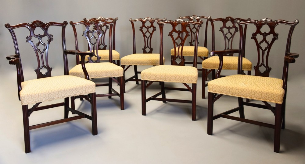 Set of eight late Victorian Chippendale style mahogany dining chairs featuring intricate pierced fretwork splats and light beige pattern-upholstered seats. View II