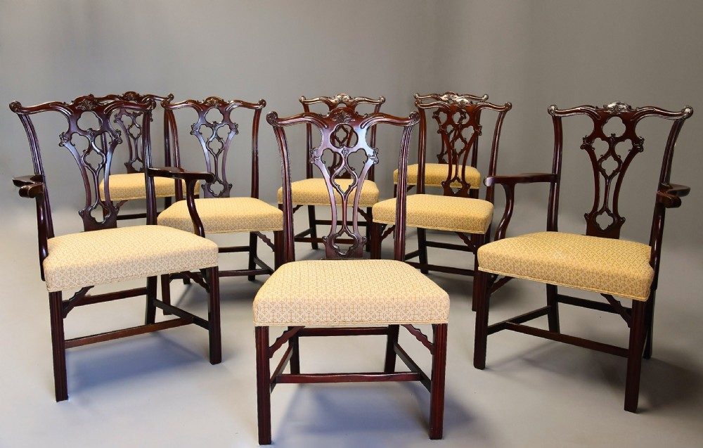 Set of eight late Victorian Chippendale style mahogany dining chairs featuring intricate pierced fretwork splats and light beige pattern-upholstered seats. View III