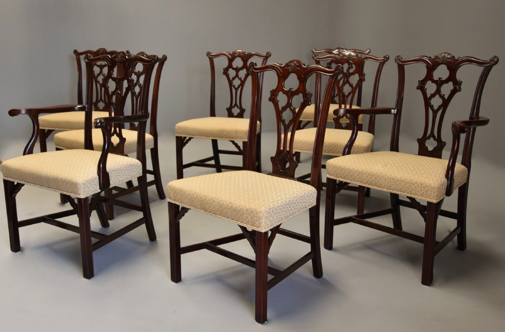 Set of eight late Victorian Chippendale style mahogany dining chairs featuring intricate pierced fretwork splats and light beige pattern-upholstered seats. View IV