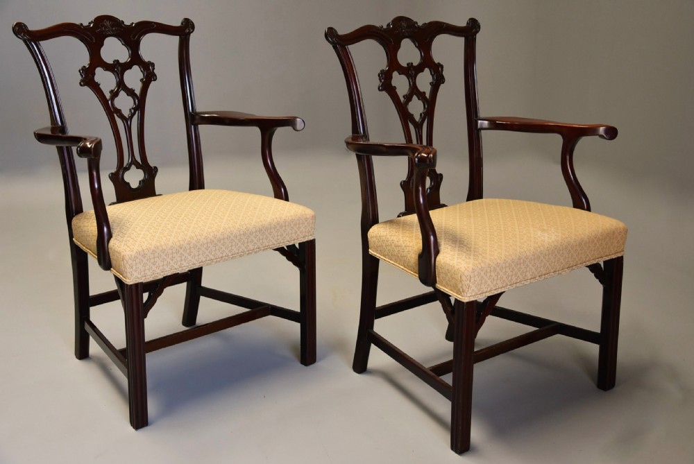 Set of eight late Victorian Chippendale style mahogany dining chairs featuring intricate pierced fretwork splats and light beige pattern-upholstered seats. View V