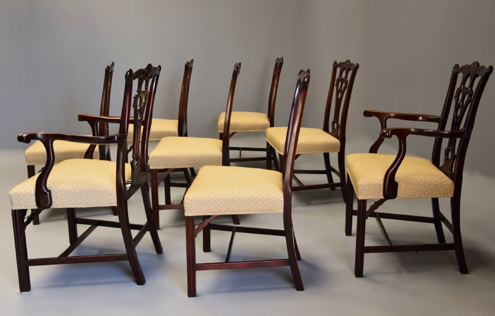 Set of eight late Victorian Chippendale style mahogany dining chairs featuring intricate pierced fretwork splats and light beige pattern-upholstered seats. View X