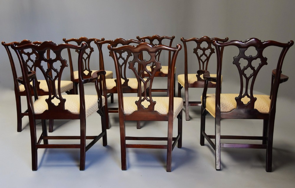 Set of eight late Victorian Chippendale style mahogany dining chairs featuring intricate pierced fretwork splats and light beige pattern-upholstered seats. View XI
