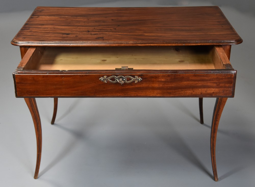 A late 18th-century French walnut side table featuring slender cabriole legs, a scalloped apron, and a single frieze drawer with a brass keyhole escutcheon. View III