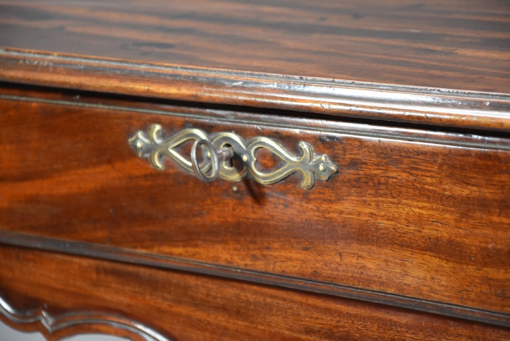 A late 18th-century French walnut side table featuring slender cabriole legs, a scalloped apron, and a single frieze drawer with a brass keyhole escutcheon. View V