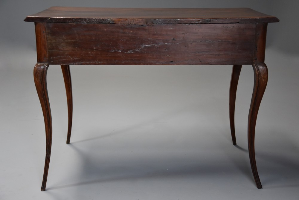 A late 18th-century French walnut side table featuring slender cabriole legs, a scalloped apron, and a single frieze drawer with a brass keyhole escutcheon. View XI