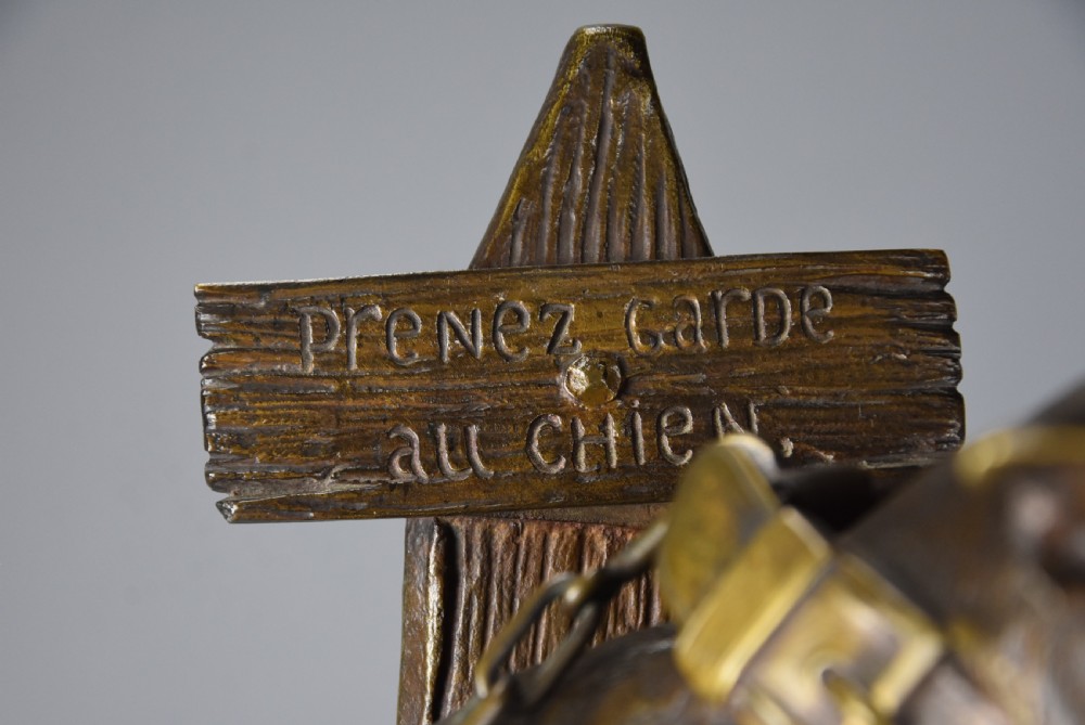 A 19th-century dark bronze sculpture of a chained guard dog rearing against a post, mounted on a brass collar and red veined marble base. View X