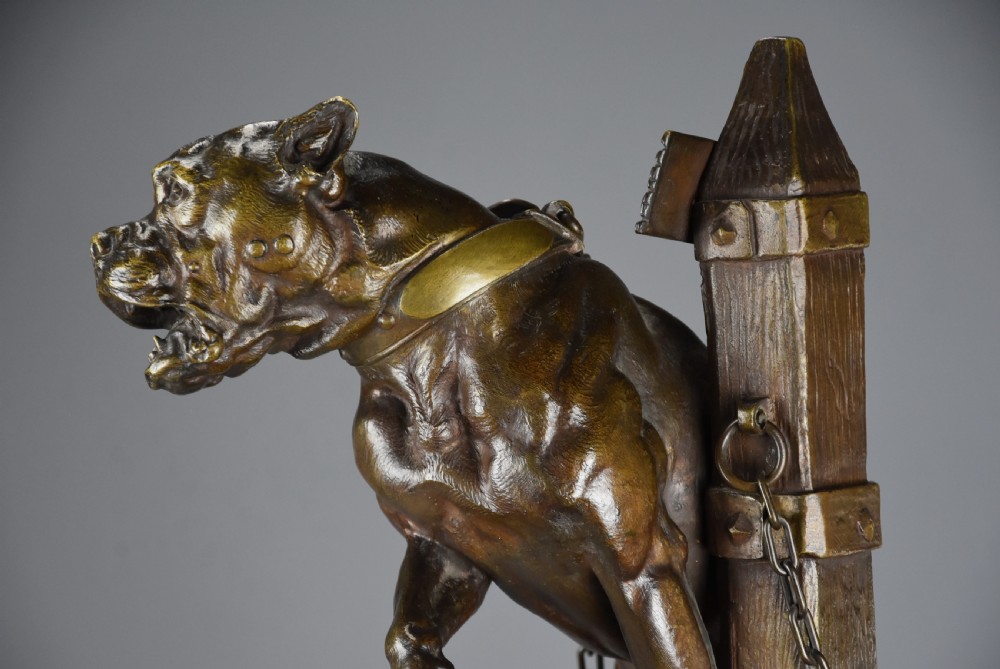 A 19th-century dark bronze sculpture of a chained guard dog rearing against a post, mounted on a brass collar and red veined marble base. View XVI