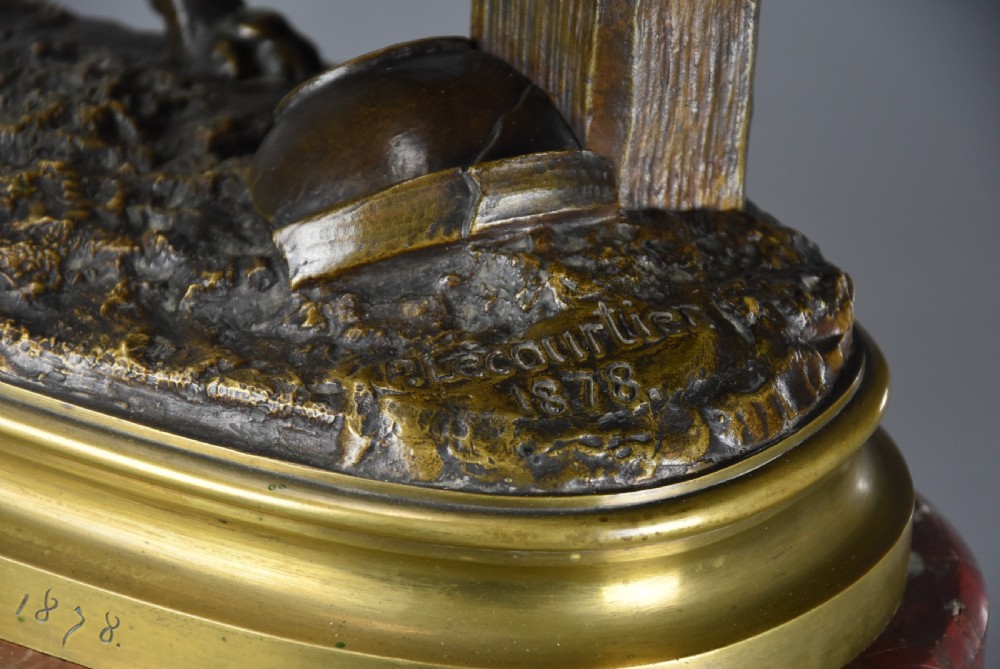 A 19th-century dark bronze sculpture of a chained guard dog rearing against a post, mounted on a brass collar and red veined marble base. View XVIII