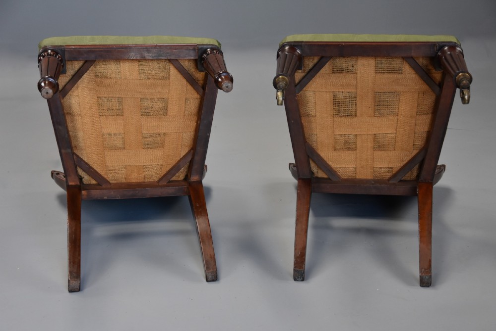 A matched set of twelve mid-19th century William IV mahogany dining chairs featuring buttoned green upholstered backrests and turned fluted front legs on brass castors. View XIV
