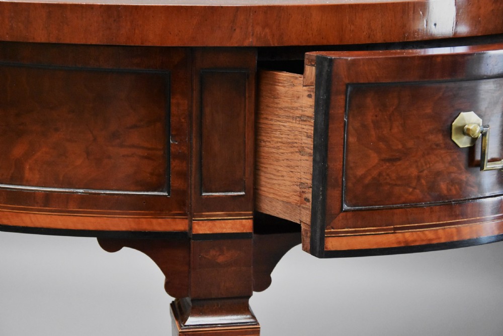 A late 18th-century Sheraton mahogany bowfront side table with two drawers, brass swan-neck handles, boxwood inlay, and square tapered legs. View XI