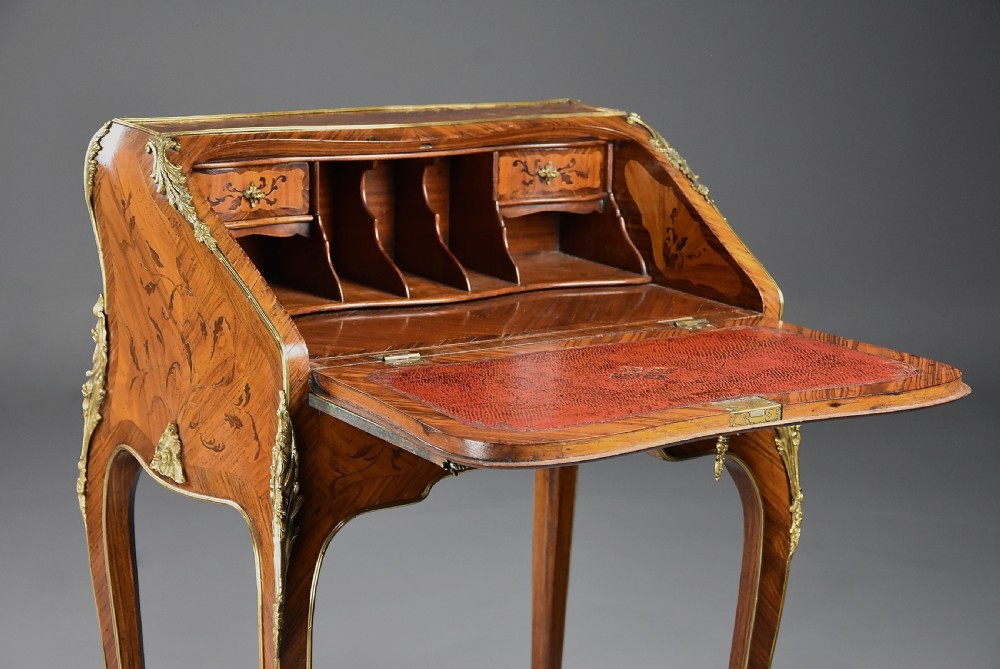 A French Louis XV style petite secretaire en pente with intricate floral marquetry veneers, gilt-bronze mounts, and cabriole legs. View V