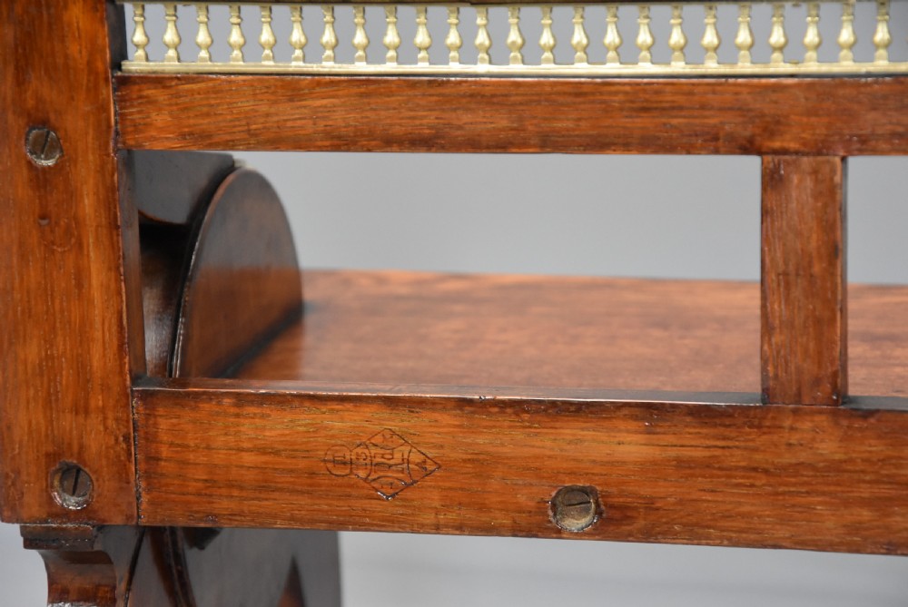 A pair of late nineteenth-century dark oak hall benches featuring carved side roundels, brass mounts, and a spindle gallery back. View XIII