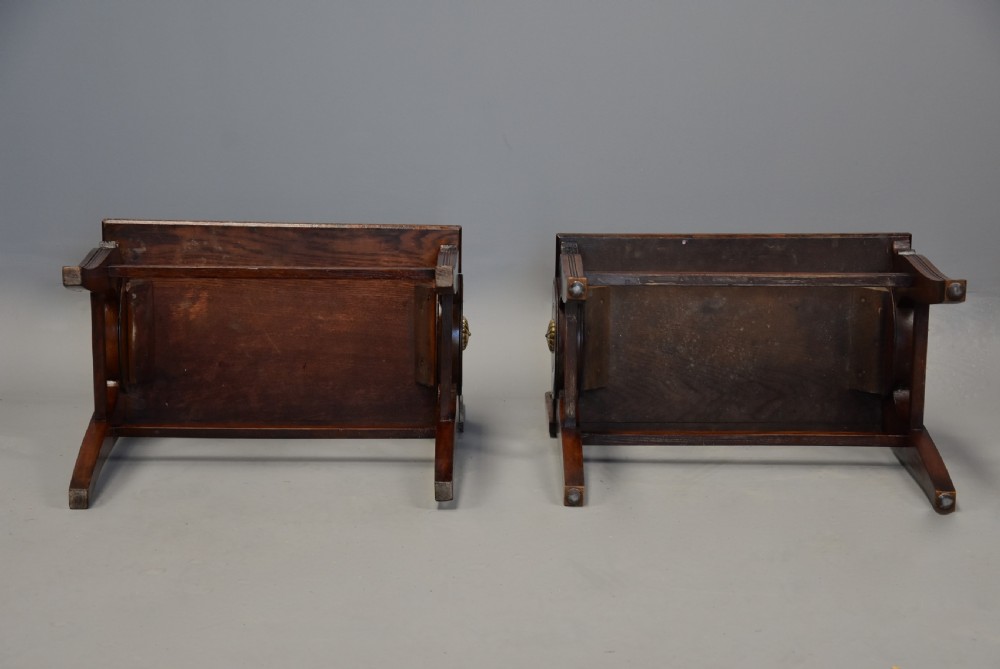 A pair of late nineteenth-century dark oak hall benches featuring carved side roundels, brass mounts, and a spindle gallery back. View XV