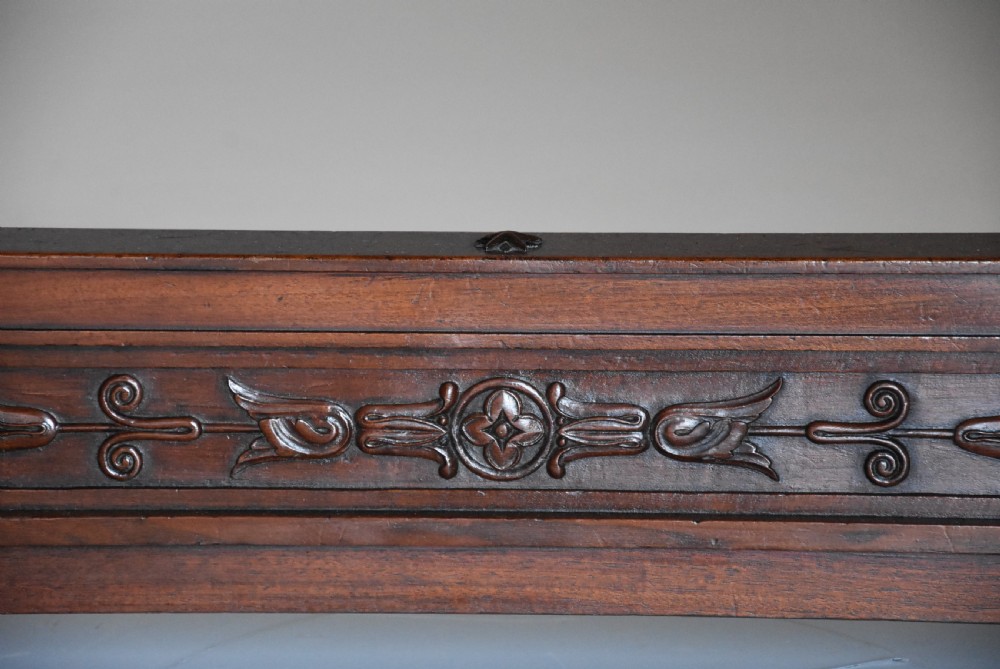 An early 19th-century French Empire mahogany centre table featuring a light marble top, carved frieze, fluted columns, and a trestle base. View XI