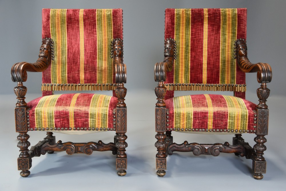 Pair of nineteenth-century French Baroque style walnut open armchairs upholstered in striped red and green velvet with carved human mask armrests. View III