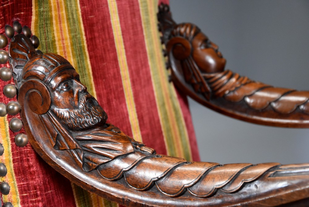 Pair of nineteenth-century French Baroque style walnut open armchairs upholstered in striped red and green velvet with carved human mask armrests. View VI