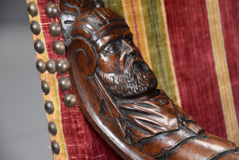 Pair of nineteenth-century French Baroque style walnut open armchairs upholstered in striped red and green velvet with carved human mask armrests. View VII