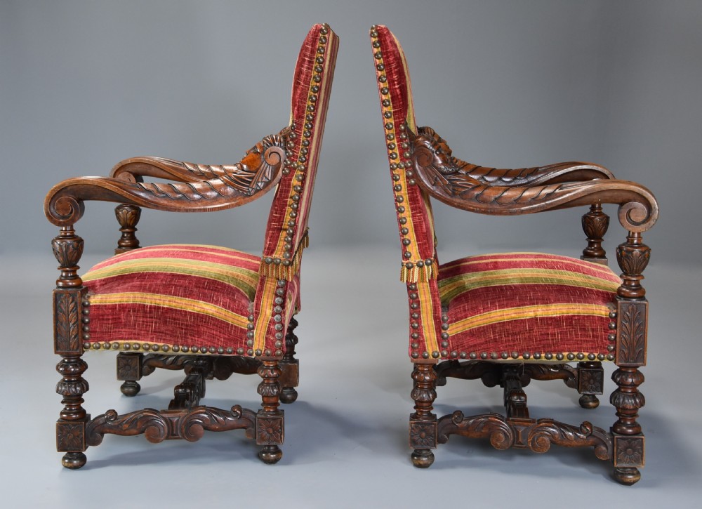 Pair of nineteenth-century French Baroque style walnut open armchairs upholstered in striped red and green velvet with carved human mask armrests. View XI