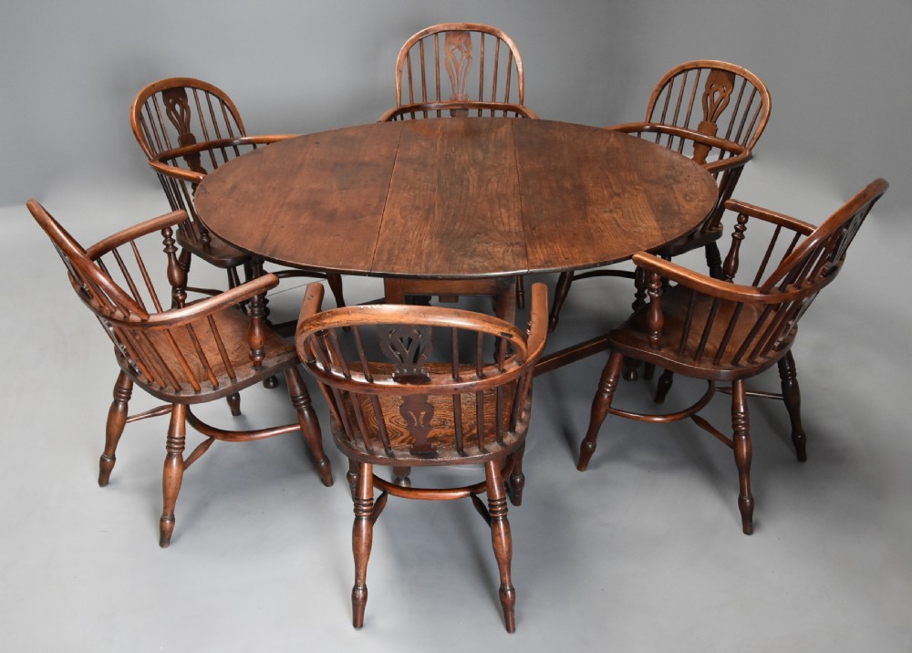 A late 17th-century oak gateleg dining table with an oval drop-leaf top, turned legs, and a small single end drawer. View VII